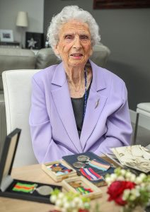 100-year-old Dorothy Craig displays memorabilia of her husband, decorated RAAF WWII veteran Lloyd Craig. Photo by Corporal Brendan Kwaterski.