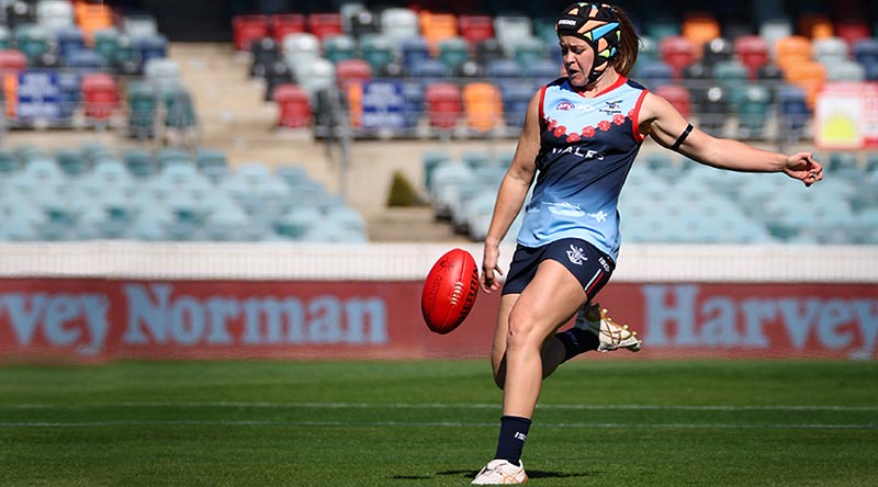 Australian Defence Force Women's All Star and Australian Army Corporal Elisha Gallagher kicks a forward 50 entry during the curtain-raiser game against the New South Wales Police Force women's team, as part of the AFL Anzac Round at Manuka Oval, Canberra on Saturday 22 April 2023. Photo by Corporal Lisa Sherman.