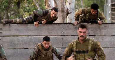 An Australian Army gunner from the 4th Regiment, Royal Australian Artillery and a French Army soldier scale the six-foot wall during a military skills competition as part of Mission Jeanne d'Arc held at Lavarack Barracks, Townsville, Queensland. Photo by Lance Corporal Riley Blennerhassett.