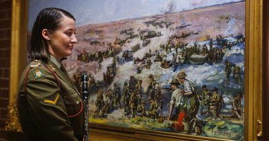 Australian Army Band member Lance Corporal Lenore Evans with a painting by her great-great-great-uncle, War Artist Frank Crozier who served at Gallipoli and in France. The painting is held by the Australian War Memorial at the Treloar Technology Centre, Canberra. Photo by Sergeant Oliver Carter.