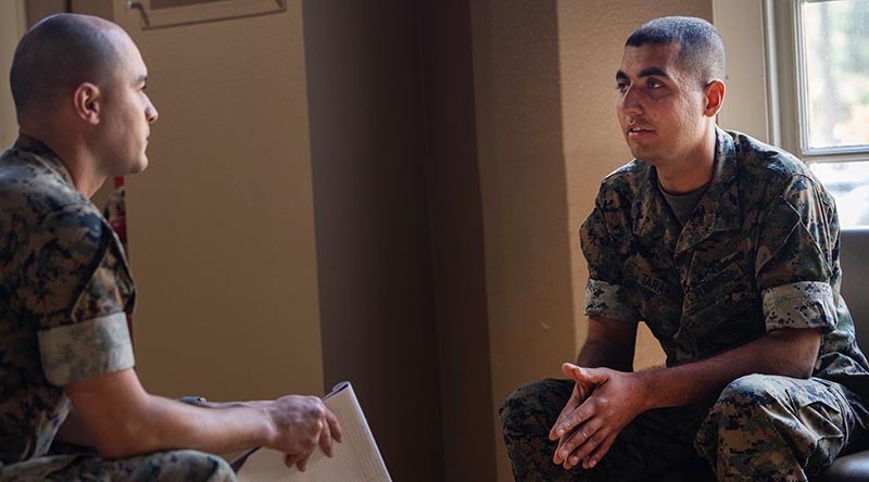 Private First Class Aimal Taraki, right, talks to Corporal Elliot Flood-Johnson from the office of Communication Strategies, at Marine Corps Recruit Depot San Diego. Photo by Lance Corporal Alex Devereux.