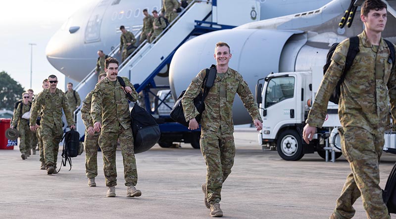 Lance Corporal Sam Kilgour, centre, disembarks a RAAF KC-30A Multi-Role Tanker Transport after his deployment on Operation Kudu. Photo by Corporal Jonathan Goedhart.