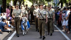 Commanding Officer 1st Battalion, Royal Australian Regiment Lieutenant Colonel Brent Hughes and mascot Corporal Septimus Quintus lead the battalion during the Anzac Day march along the Strand in Townsville. Photo by Lance Corporal Riley Blennerhassett.