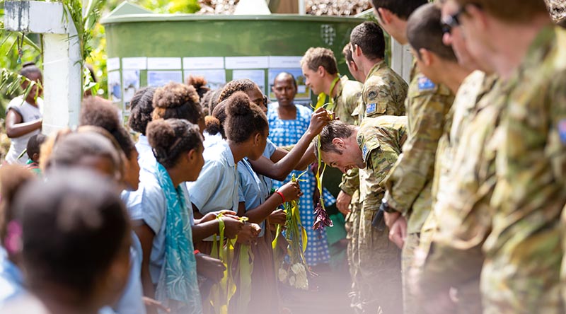 Lance Corporal Angus Brownlie and members of 6th Engineer Support Regiment receive gifts from students of the Etas Grace Primary School in Port Vila after completion of Operation Vanuatu Assist 2023 engineering works. Photo by Leading Seaman Matthew Lyall.