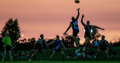 Players from the men's ADF and NT PFES teams vie for the ball during the ANZAC Shield charity AFL match at TIO Stadium, Darwin, NT. Photo by Signalman Kobi Rankin.