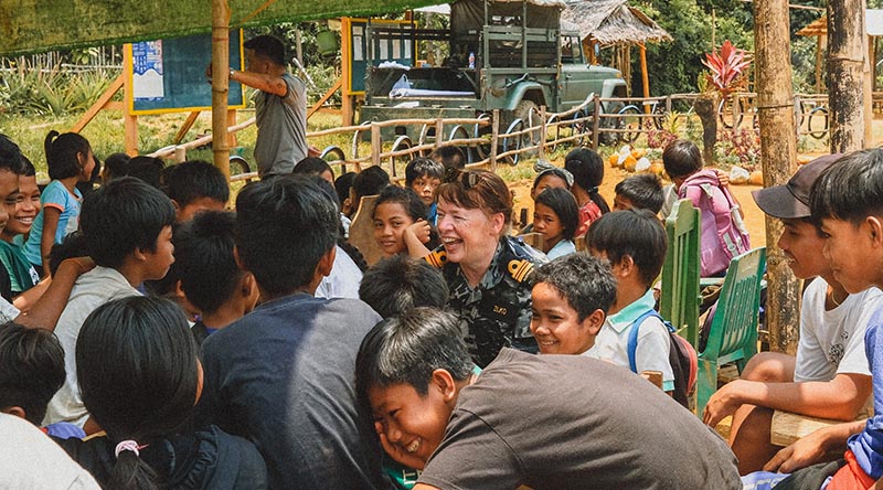 Royal Australian Navy officer Lieutenant Commander Alison Zilko speaks with school kids in the Philippines in her role as ADF Gender Advisor during Exercise Balikatan 2023.