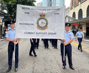 Royal Australian Air Force Combat Support Group aviators march behind Combat Support Groups banner celebrating the group's 25th birthday, during the Anzac Day 2023 parade in Brisbane, Queensland.