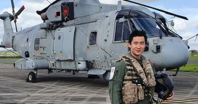 Lieutenant Daniel Cochrane with the Merlin HM2 he flies on exchange with Royal Navy 820 Squadron in the United Kingdom.