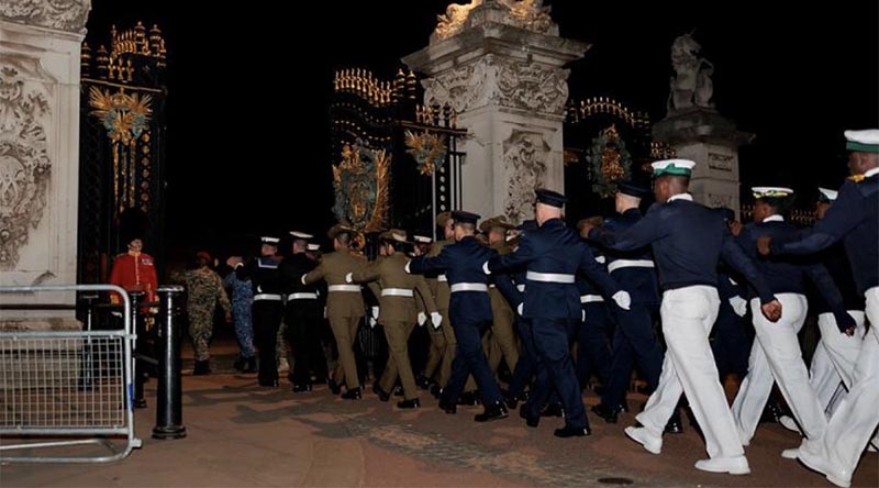 Australia's Federation Guard members march with the Commonwealth contingent into Buckingham Palace gardens during a night rehearsal for the King's Coronation. Photo by Sergeant Andrew Sleeman.