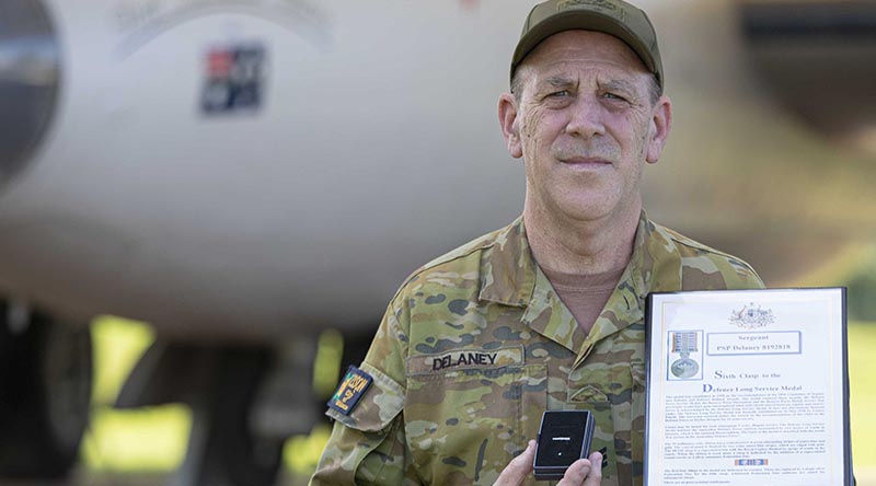 Sergeant Peter Delaney, from Weapon Training Section at No.23 Squadron, displays his second Federation Star and sixth clasp to his Defence Long Service Medal, for 45 years of service with the Royal Australian Air Force, at RAAF Base Amberley, Queensland. Photo by Leading Aircraftwoman Taylor Anderson.