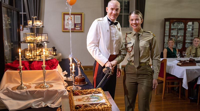 Lieutenant Colonel Anthony Craig and Private Paris Plate cut the birthday cake at the celebration of the Royal Australian Army Dental Corps' 80th anniversary. Photographer unknown. Cake, lost when photo cropped to fit formatting, digitally replaced in photo by CONTACT.
