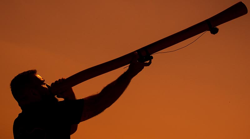 Navy Regional Indigenous Development Coordinator Leading Seaman Joseph Canning plays the didgeridoo at ANZAC Cove during an ANZAC Day rehearsal on the Gallipoli peninsula in Türkiye. Photo by Corporal Madhur Chitnis.