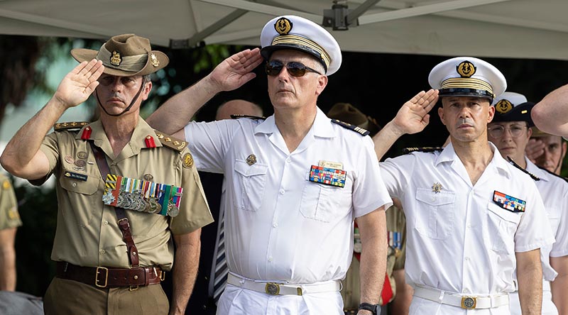 Commander Combat Training Centre Colonel Benjamin McLennan, Captain of the FS La Fayette Capitaine Jean, and Captain of the FS Dixmude Capitaine Emmanuel salute during the French national anthem at a wreathe-laying ceremony at ANZAC Memorial Park in Townsville. Photo by Lance Corporal Riley Blennerhassett.