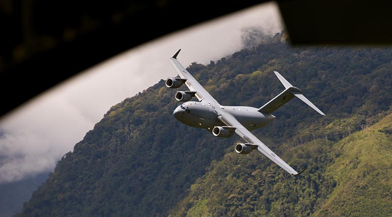 A No. 36 Squadron C-17A Globemaster III aircraft, viewed from a USAF C-17, performs a low level navigation sortie through the Papua New Guinea highlands during Exercise Global Dexterity 23-1. Photo by Corporal Kieren Whiteley.
