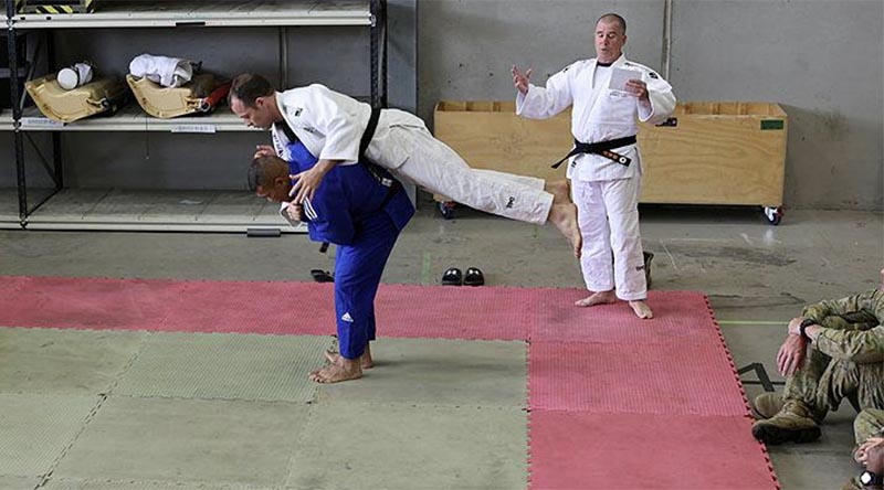 Private Feao Faka’Osi, in blue, demonstrates one of his favourite techniques, called ippon seoinage, on Lieutenant Colonel Morgan McCarthy during a judo demonstration.