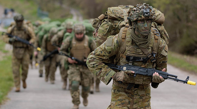 An Australian Army soldier deployed on Operation Kudu leads recruits from the Armed Forces of Ukraine as they march to a field training area in southern England. Photo by Sergeant Andrew Sleeman.