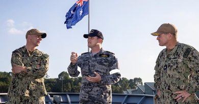 Executive Officer of HMAS Perth Lieutenant Commander Grant Hamilton (centre) talks to US Navy officers from USS Charleston during their visit to HMAS Perth alongside Sembawang, Singapore. Photo by Leading Seaman Sittichai Sakonpoonpol.