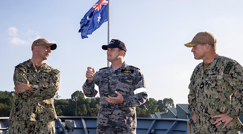 Executive Officer of HMAS Perth Lieutenant Commander Grant Hamilton (centre) talks to US Navy officers from USS Charleston during their visit to HMAS Perth alongside Sembawang, Singapore. Photo by Leading Seaman Sittichai Sakonpoonpol.