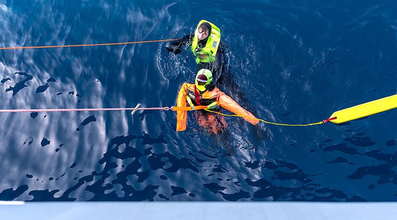 HMAS Anzac swimmer of the watch Able Seaman Mitchell Donovan conducts a rescue swim during a man overboard exercise as a part of Exercise Bersama Shield 2023. Photo by Leading Seaman Jarryd Capper.