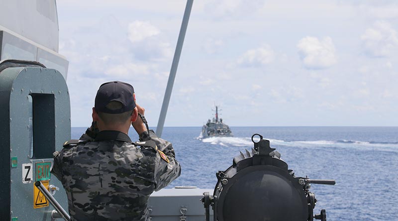 Midshipman Jin You takes ranges to ADV Cape Naturaliste from HMAS Broome during officer-of-the-watch training. Photo by Able Seaman Elise Cowley.