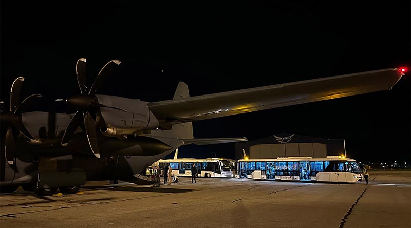 Evacuees from Port Sudan on board buses after departing the Royal Australian Air Force C-130J Hercules aircraft at Cyprus. Photo by Sergeant Jarrod McAneney.