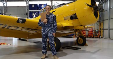 Personnel Capability Specialist at No. 100 Squadron Leading Aircraftwoman Casey-Lee Rebellato in front of a Harvard aircraft at RAAF Base Point Cook. Photo by David Jones.