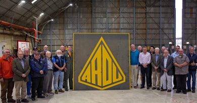 Squadron Leader Dawson Schuck (centre left) from ARDU, donates the old ARDU hangar sign to the President of the South Australian Aviation Museum (SAAM) Nigel Daw (centre right), during a SAAM visit to RAAF Base Edinburgh. Photo by Sergeant Nicci Freeman.
