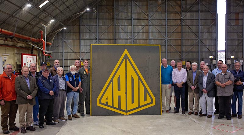 Squadron Leader Dawson Schuck (centre left) from ARDU, donates the old ARDU hangar sign to the President of the South Australian Aviation Museum (SAAM) Nigel Daw (centre right), during a SAAM visit to RAAF Base Edinburgh. Photo by Sergeant Nicci Freeman.