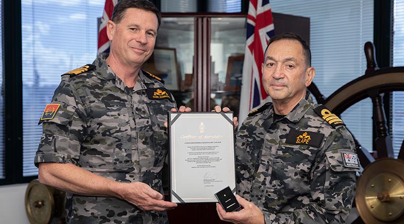 Chief of Navy Vice Admiral Mark Hammond presents a Federation Star to Commander Bertram Slape, marking 50 years’ service in the Royal Australian Navy. Photo by Petty Officer Christopher Szumlanski.