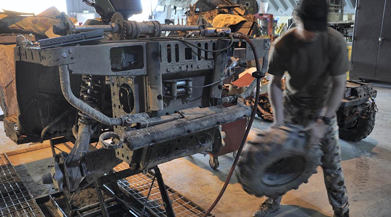 A vehicle mechanic from the Special Operations Task Group’s (SOTG’s) Combat Service Support Team (CSST) undertakes repairs on an all-terrain vehicle required by special-forces soldiers. Photo by Lieutenant Aaron Oldaker.