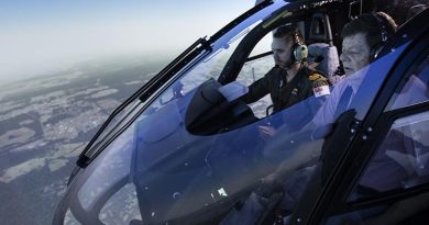 Lieutenant Cody Sinclair instructs Roger Campbell, a winner of the Variety flight simulator experience at 723 Squadron HMAS Albatross. Photo by Petty Officer Kayla Jackson.