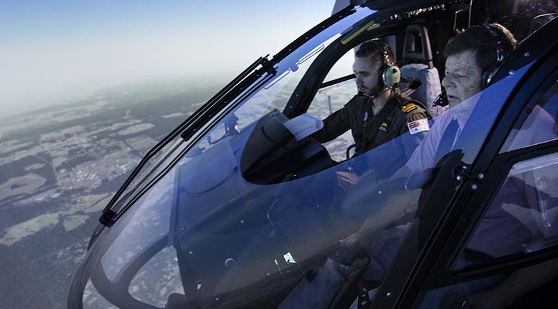 Lieutenant Cody Sinclair instructs Roger Campbell, a winner of the Variety flight simulator experience at 723 Squadron HMAS Albatross. Photo by Petty Officer Kayla Jackson.