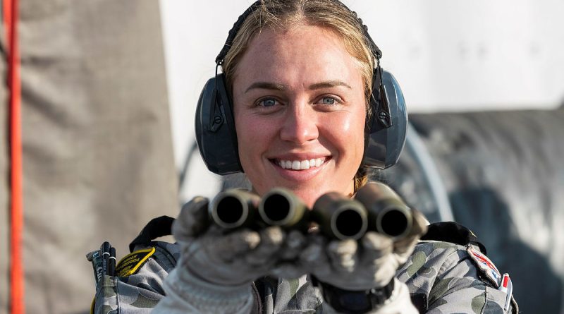 Leading Seaman Esther Melvin holds 25mm Typhoon shells following a live-fire activity on HMAS Canberra as the ship makes its way to Exercise Talismans Sabre in 2021. Story by Private Nicholas Marquis. Photo by Leading Seaman Sittichai Sakonpoonpol.