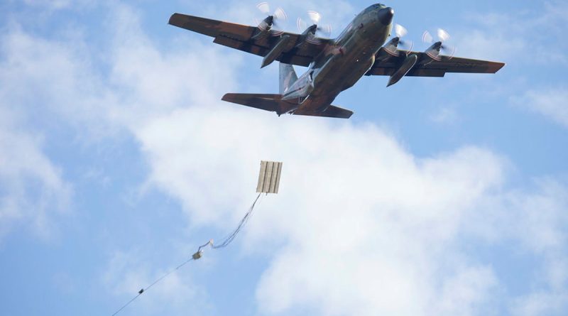 A Republic of Singapore Air Force C-130H Hercules drops a heavy equipment platform. Story by Tastri Murdoch. Photo by Aircraftwoman Maddison Scott.