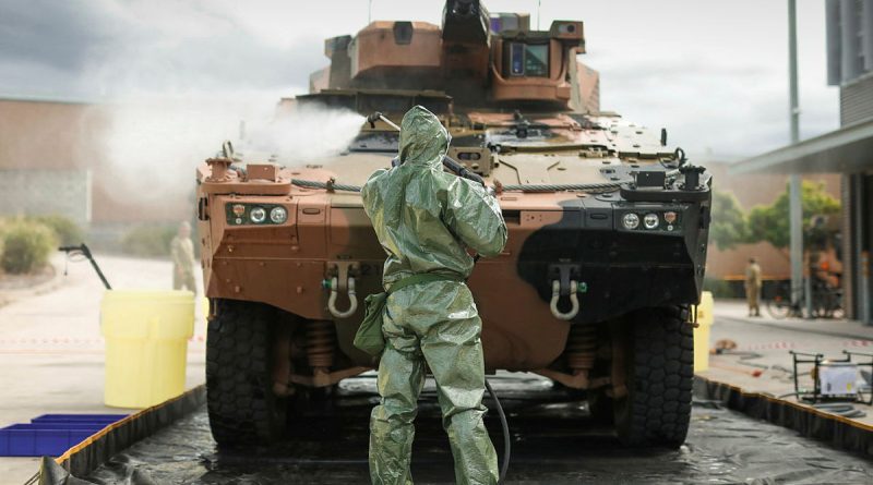 Australian Army sappers from the 2nd Combat Engineer Regiment hose down a Boxer combat reconnaissance vehicle in a decontamination bay. Story by Captain Cody Tsaousis. Photo by Sapper Tristan Montagu.