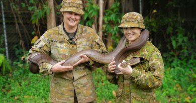 Privates Leah Gustafson and Sylvia Ng from 2nd Health Battalion hold an Olive Python during the venomous snake handling and relocation course at Gallipoli Barracks, Brisbane. Story and photo by Private Thomas de Weger.