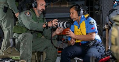 Loadmaster Flight Sergeant Christian Allison of 35 Squadron teaches Samoan police officer Constable Fetuao Nuuvali how to use the camera during Operation Solania. Photos by Leading Aircraftman Chris Tsakisiris.