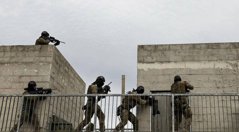 Soldiers from the 5th Brigade clear a building using airsoft rifles at Holsworthy Training Area at the end of Exercise Arras Sprint. Story by Major Jesse Robilliard. Photo by Private Sarah Fisher.