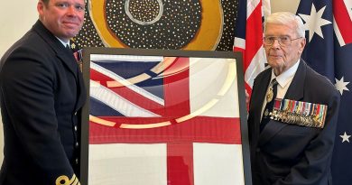 Rear Admiral (retd) Guy Griffiths, right, presents the Royal Navy ensign to Commanding Officer HMS Prince of Wales Captain Richard Hewitt. Story by Lieutenant Charlie Marshall.