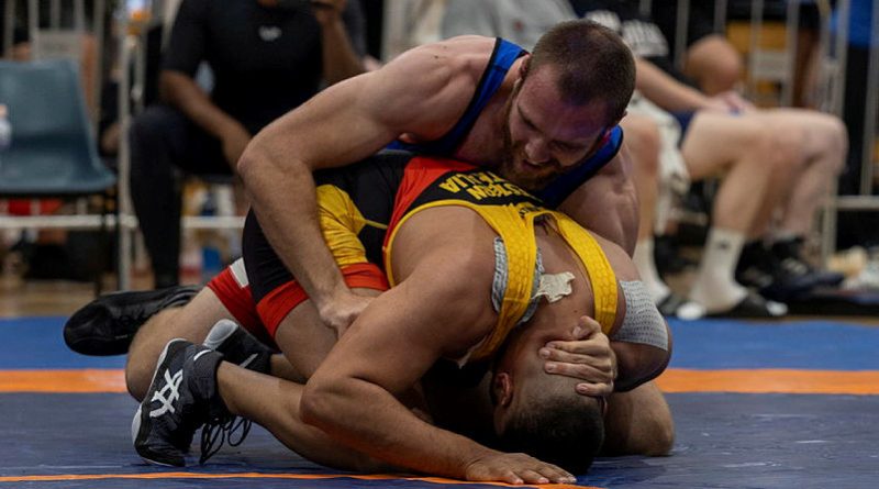 Navy Able Seaman Kyle Mainey, in blue, competes in the freestyle wrestling 92kg division at the 2023 Senior National Wrestling Championships at PCYC Lang Park, Brisbane. Story and photo by Corporal Jacob Joseph.