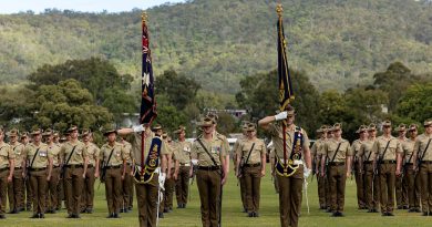 Soldiers of the 6th Battalion, Royal Australian Regiment stand to attention during the battalion's King's and Regimental Colours Parade. Story and photo by Corporal Jacob Joseph.