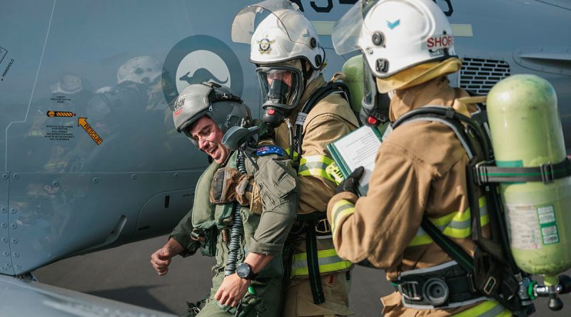 Air Force fire fighters evacuate a simulated casualty from a PC-21 aircraft during a crash exercise at RAAF Base Williamtown, NSW. Story by Wing Commander Sue Yates. Photos by Leading Aircraftman Samuel Miller.
