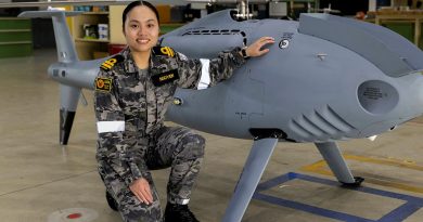Lieutenant Fiona Nguyen in front of a Shiebel S-100 air vehicle at 822X Squadron, HMAS Albatross. Story by Captain Karam Louli. Photo by Petty Officer Justin Brown.