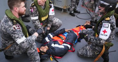 Leading Seaman Ryan Feenan, Leading Seaman Aaron Evans and medical officer Lieutenant Jarrad Blackburn provide care to an injured mariner aboard an oil tanker during a medical evacuation in the Southern Indian Ocean. Story by Lieutenant Max Logan. Photo by Tyson Burraston.