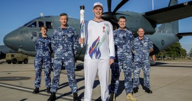 Legacy Centenary Torch Relay Bearer Nicholas Paske (centre) with Air Force personnel (L-R) Leading Aircraftwoman Sarah Negrin, Warrant Officer Scott Biddell, Flight Lieutenant Brett Smith and Flight Sergeant Shawn Spry in front of a C-27J Spartan at RAAF Base Amberley, Queensland. Story by Flight Lieutenant Greg Hinks. Photo by Leading Aircraftwoman Taylor Anderson.