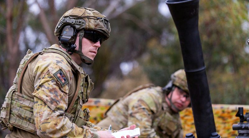 A soldier from the 5th/6th Battalion, Royal Victoria Regiment prepares to record firing orders next to an 81mm mortar at Puckapunyal training area, Victoria. Story by Captains Andrew Lee and Mark Blackman. All photos by Corporal Michael Currie.