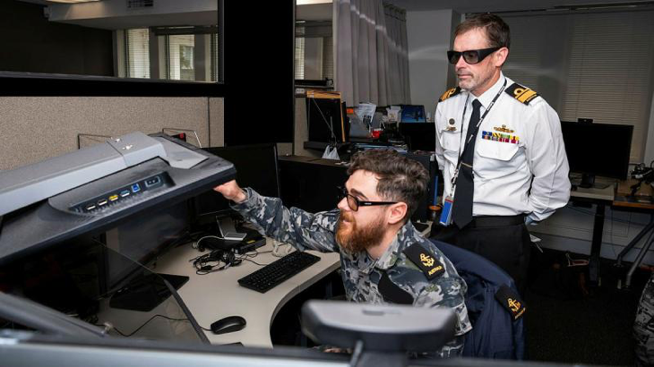 Leading Seaman M demonstrates the precise point mensuration process to Head of Navy Capability Rear Admiral Stephen Hughes at Air Force’s 460 Squadron.