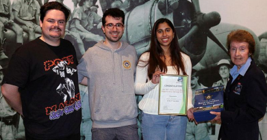 Wagga Aviation Heritage Centre volunteer Christine Wyatt presents Erika Mendes with a certificate and book set, while Kieren Johnston and Haig Vartoukian look on. Story by Flight Lieutenant Karyn Markwell. Photo by Peter Wyatt.