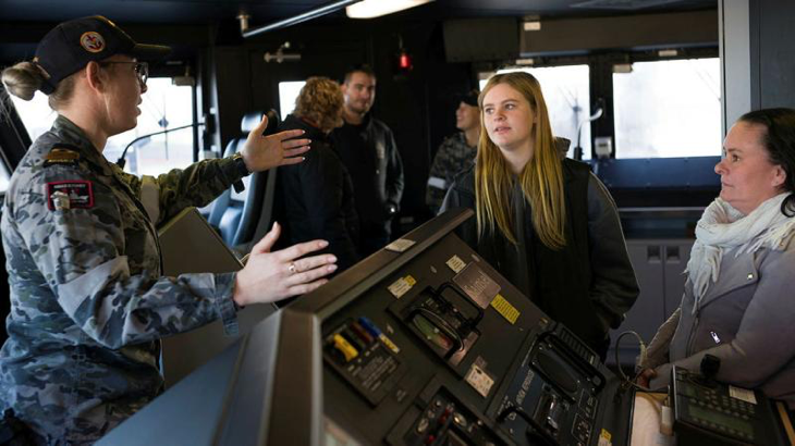 An HMAS Sydney crew member teaches visitors about the ship during an open day. Story by Lieutenant Samantha Robson. All photos by Tyson Burraston.