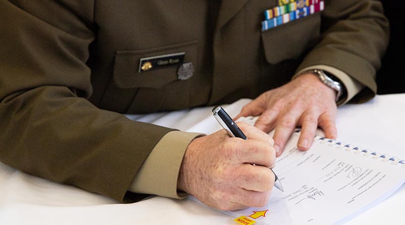 Director General Training and Doctrine Brigadier Glenn Ryan signs the Joint Technical Trades and Training Services (JTTS) contract at the Australian Defence Force Academy in Canberra. Photo by Leading Seaman Tara Morrison.